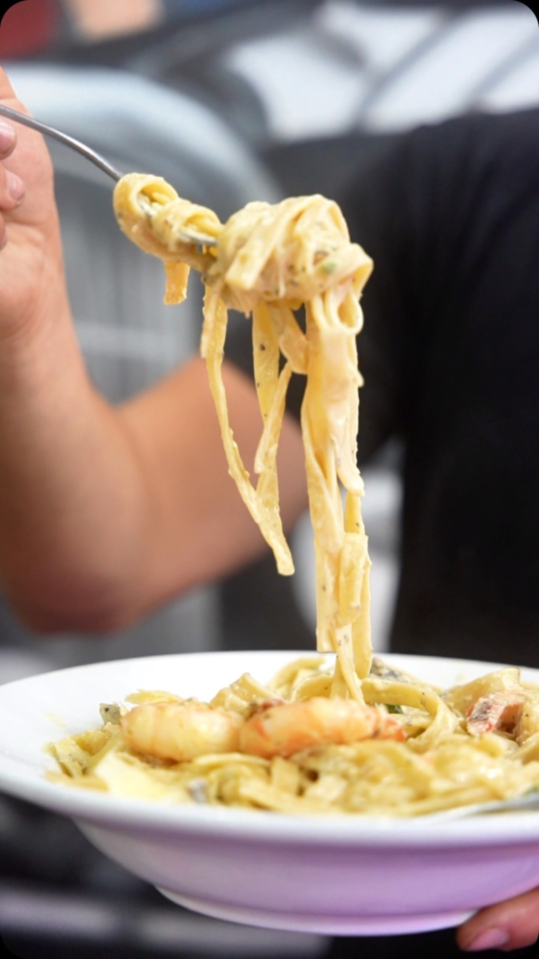Fettuccine being lifted from the plate